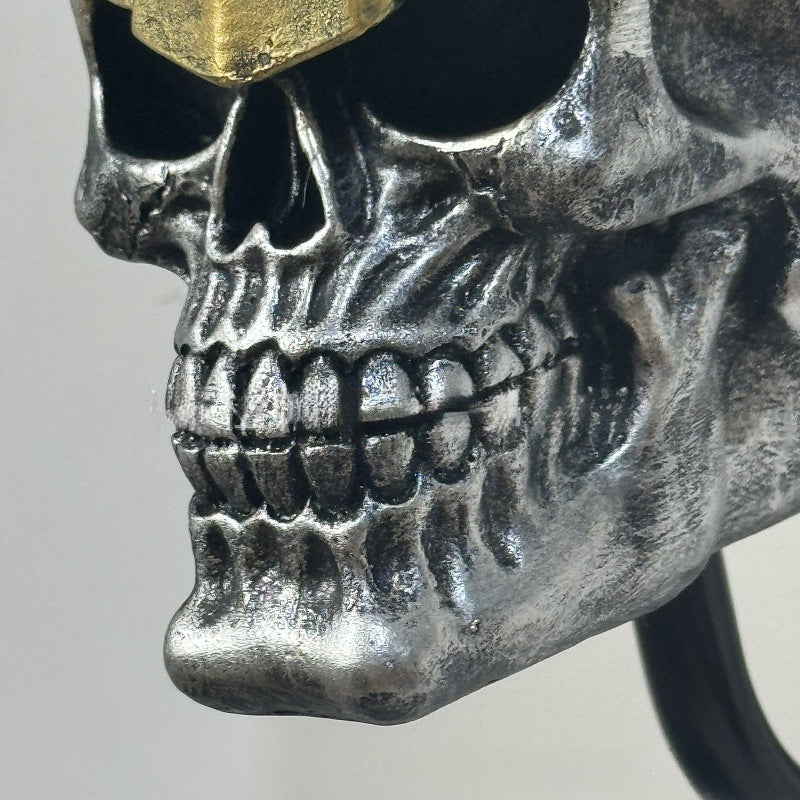 Decorative helmet holder with skull made of synthetic resin